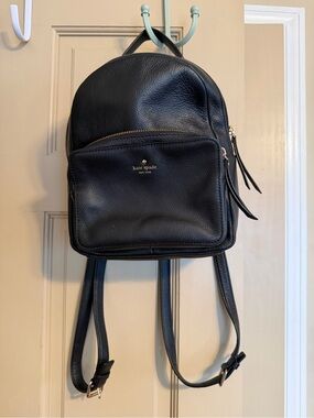 kate spade black logo-lined handbag interior with gold foil badge
